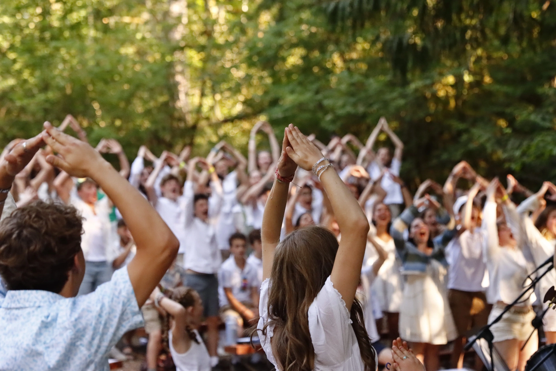 Community celebrating together with hands raised
